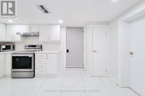 St. Catharines (Port Dalhousie) apartment for rent - A white kitchen with a stainless steel oven and white cabinets.