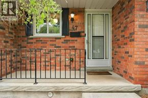Kitchener apartment for rent - A brick house with a glass door and a sign that says REALTOR.