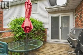 Kitchener apartment for rent - A red umbrella is on a glass table.