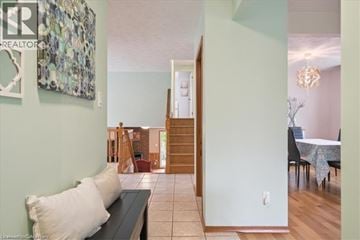 Kitchener apartment for rent - A living room with a couch and a dining table.