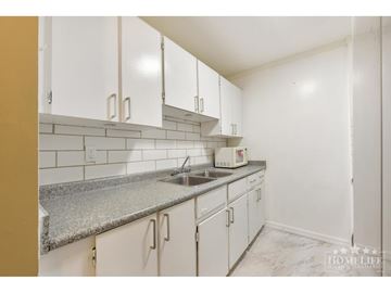 Surrey apartment for rent - A kitchen with white cabinets and a granite countertop.
