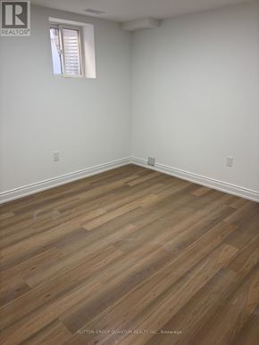Brampton (Bram East) apartment for rent - A room with wooden flooring and a window.