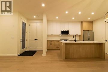Calgary apartment for rent - A modern kitchen with wooden cabinets and a black mat on the floor.