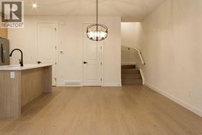 Calgary apartment for rent - A well-lit kitchen with wooden floors and a staircase in the background.