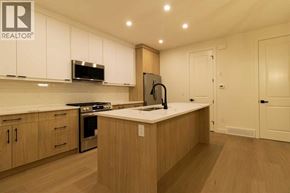 Calgary apartment for rent - A kitchen with wooden cabinets and a stainless steel refrigerator.