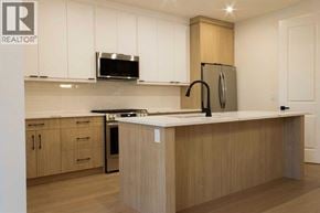 Calgary apartment for rent - A kitchen with wooden cabinets and a white countertop.