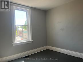 Arran-Elderslie apartment for rent - A brown wooden staircase with a white railing.