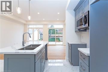 Hamilton apartment for rent - A modern kitchen with a sink and a microwave.