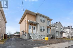 Cornwall triplex for rent - A two-story house with a garage is for sale.