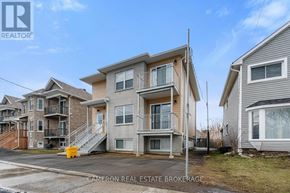 Cornwall triplex for rent - A row of houses with the middle one being the largest.