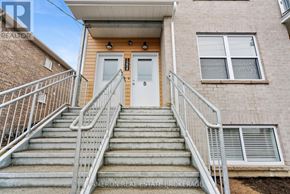 Cornwall triplex for rent - A house with a staircase leading to the front door.