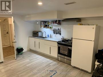 Barrie (Allandale Heights) apartment for rent - A kitchen with white appliances and cabinets.
