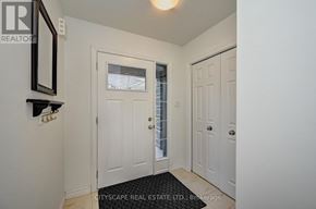 Kitchener townhouse for rent - A house with a green door and a garage door.