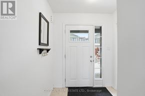 Kitchener townhouse for rent - A white door with a glass window is in a hallway.