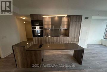 Toronto (Annex) condo for rent - A modern kitchen with a wooden island and stainless steel appliances.