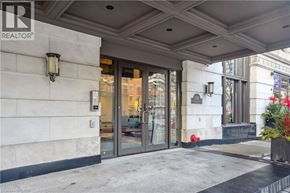Hamilton condo for rent - The image shows the front of a building with a glass door entrance and a sign that reads REALTOR.