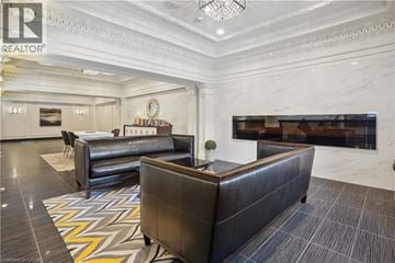 Hamilton condo for rent - A living room with a black sofa and a grey couch.