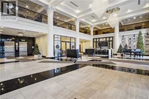 Hamilton condo for rent - A large, well-lit lobby with a Christmas tree and a "REALTOR" sign.