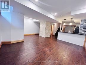 Oakville (Go Glenorchy) apartment for rent - A spacious room with wooden flooring and a reception desk.