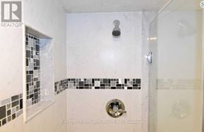 Oakville (Go Glenorchy) apartment for rent - A white bathroom with a shower and a tile border.