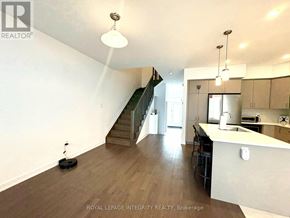 Ottawa townhouse for rent - A white sink in a small bathroom with a brown cabinet.