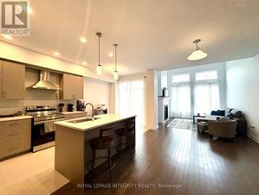 Ottawa townhouse for rent - A staircase with a black railing and a white wall.