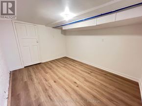 Toronto (South Riverdale) apartment for rent - A room with wooden flooring and a white door.