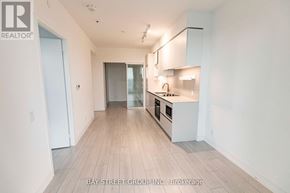 Vaughan (Vaughan Corporate Centre) condo for rent - A spacious kitchen with white cabinets and a wooden floor.