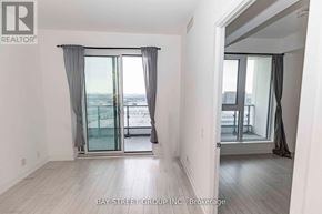 Vaughan (Vaughan Corporate Centre) condo for rent - A room with a view of the city through a glass door.