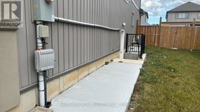 Thorold (Rolling Meadows) apartment for rent - A grey building with a sign that says REALTOR on it.