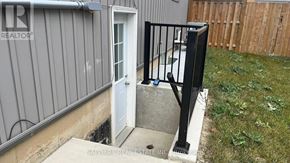 Thorold (Rolling Meadows) apartment for rent - A small white door is open to a concrete step.