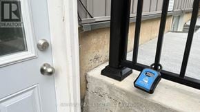 Thorold (Rolling Meadows) apartment for rent - A blue device is sitting on a concrete ledge next to a black railing.