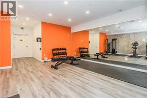 Kitchener condo for rent - A gym with orange walls and wooden floors.