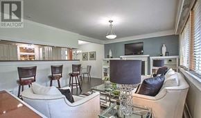 Newmarket (Central Newmarket) apartment for rent - A living room with a couch, chairs, and a television.