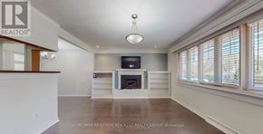Newmarket (Central Newmarket) apartment for rent - A spacious living room with a fireplace and a flat screen TV.