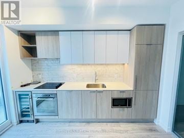 Toronto (Humewood-Cedarvale) condo for rent - A modern kitchen with a stainless steel sink and oven.