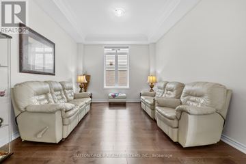Brant (Paris) apartment for rent - A living room with two beige sofas and a coffee table.