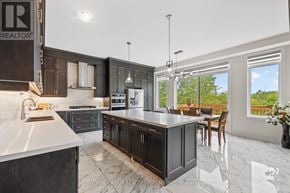 Brant (Paris) apartment for rent - A modern kitchen with dark wood cabinets and a marble countertop.
