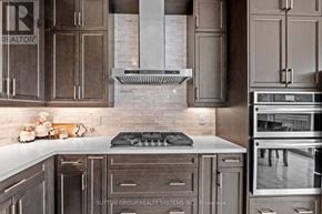 Brant (Paris) apartment for rent - A kitchen with a stove top oven and a range hood.
