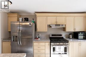 Fort Erie (Crystal Beach) apartment for rent - A kitchen with a stainless steel refrigerator and a white oven.