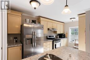 Fort Erie (Crystal Beach) apartment for rent - A kitchen with a refrigerator, microwave, and oven.