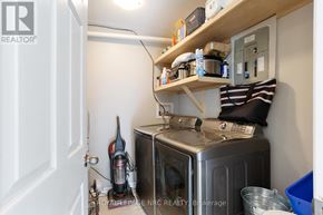 Fort Erie (Crystal Beach) apartment for rent - A small kitchen with a refrigerator, a vacuum cleaner, and a few other items.