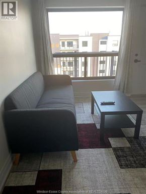 Windsor condo for rent - A living room with a grey couch and a black coffee table.