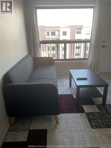 Windsor condo for rent - A living room with a grey couch and a black coffee table.