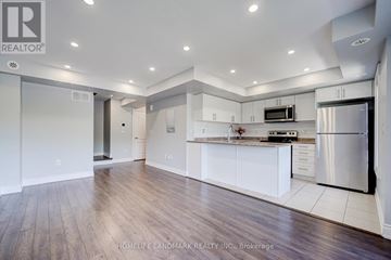 Markham (Cornell) townhouse for rent - A modern kitchen with white cabinets and a stainless steel refrigerator.
