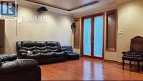 Vancouver apartment for rent - A living room with a black leather couch and a wooden chair.