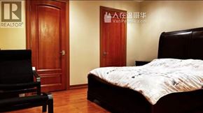 Vancouver apartment for rent - A bedroom with a bed, chair, and a door with a sign on it.
