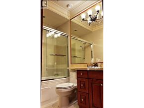 Vancouver apartment for rent - A bathroom with a toilet, sink and mirror.