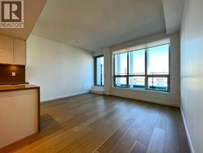 Vancouver apartment for rent - A spacious room with wooden flooring and large windows.