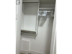 Vancouver townhouse for rent - A white closet with a hanging rod and shelf.